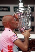 Marco Pantani of Italy kisses the winner's cup on the podium of the last stage of the Tour of Italy cycling race in Milan, Sunday June 7, 1998. Italy's superstar Marco Pantani won the cycling marathon in 95 hours 50 minutes and seconds 39, Pavel Tonkov of Russia was second and Italian Giuseppe Guerini third. (AP Photo/Alessandro Trovati)